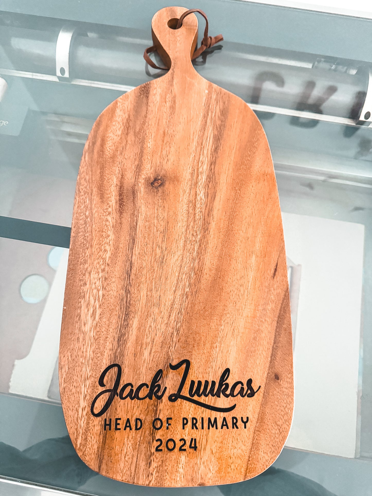 Acacia board with 3 words engraved at the bottom