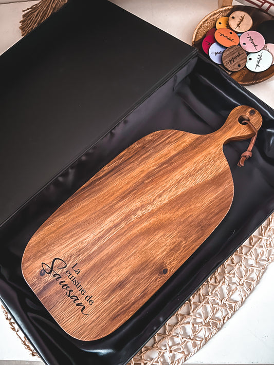 Acacia board with 3 words engraved at the bottom